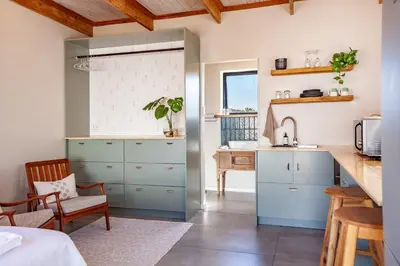 a kitchen with blue cabinets and a sink at Lily's Pad in Oakdale