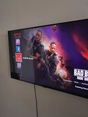 a flat screen tv with a movie on it at Yannas Guesthouse in Cape Town