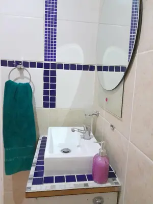 a bathroom with a sink and a mirror at Yannas Guesthouse in Cape Town