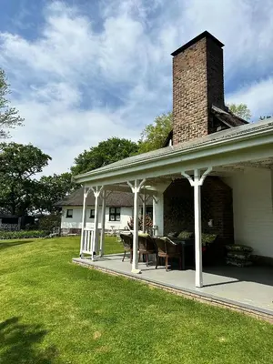 a pavilion on a house with a brick chimney at Blossom Cottage, Elgin Grabouw in Grabouw