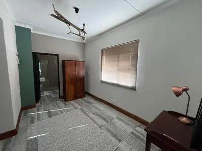 an empty living room with a window and a table at Te Môi in Paarl