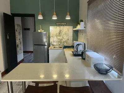 a kitchen with a counter top and a refrigerator at Te Môi in Paarl