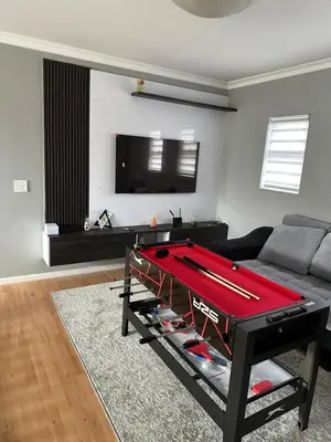 a living room with a pool table in front of a couch at YA Eagle Wings Self Catering Shared Single room Apt B in Cape Town