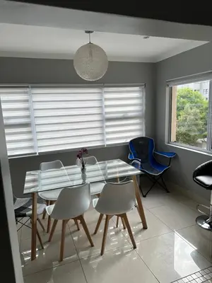 a dining room with a glass table and chairs at YA Eagle Wings Self Catering Shared Single room Apt B in Cape Town