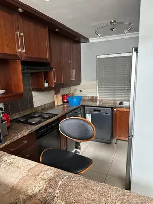 a kitchen with a counter and a chair in it at YA Eagle Wings Self Catering Shared Single room Apt B in Cape Town