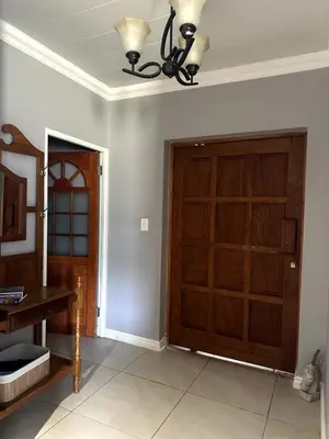 a room with a wooden door and a ceiling at Laid-Back Tortoise in Fisherhaven