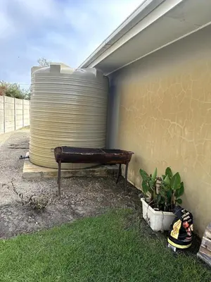 a bench sitting next to a wall with a can at Laid-Back Tortoise in Fisherhaven