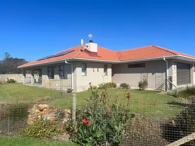 a house with a fence in front of it at Laid-Back Tortoise in Fisherhaven