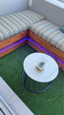 a white coffee table sitting next to a couch at 2 bed Luxury apartment living in Cape Town
