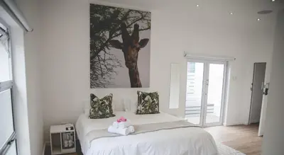 a bedroom with a bed with two stuffed animals on it at theLAB Franschhoek in Franschhoek