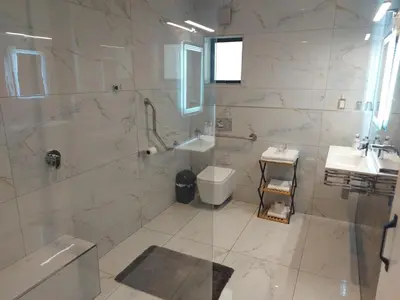 a bathroom with a shower and a toilet and a sink at AnnaNella Boutique Hotel in Durbanville