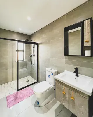 a bathroom with a toilet and a sink and a shower at Goodness Century Apartment in Cape Town