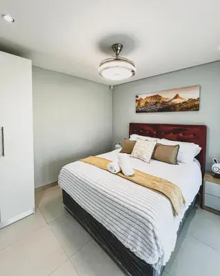 a bedroom with a large bed in a room at Goodness Century Apartment in Cape Town