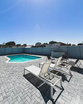 a patio with chairs and a swimming pool at Goodness Century Apartment in Cape Town