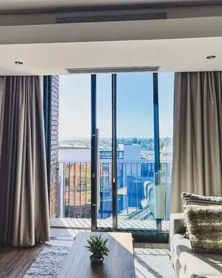 a living room with a large window with a view at Shalom on Matrix by Dajosha in Cape Town