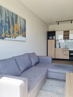 a living room with a couch and a painting on the wall at On Park by Smart City Stays in Cape Town