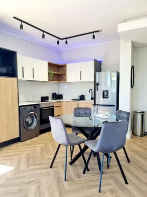 a kitchen with a dining room table and chairs at On Park by Smart City Stays in Cape Town