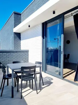 a patio with a table and chairs on a balcony at On Park by Smart City Stays in Cape Town