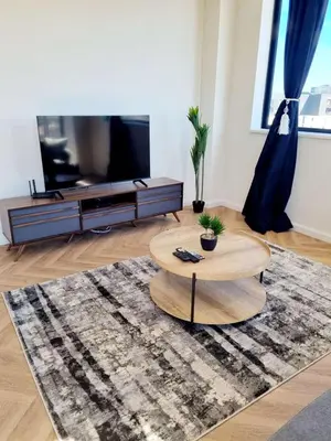 a living room with a coffee table and a flat screen tv at On Park by Smart City Stays in Cape Town