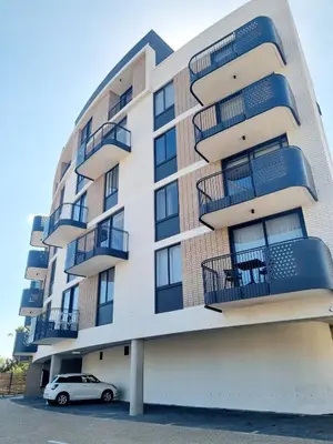 a building with balconies and a car parked in front at On Park by Smart City Stays in Cape Town