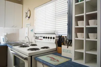 a kitchen with a white stove top oven in a kitchen at 9 Lantra in Strand