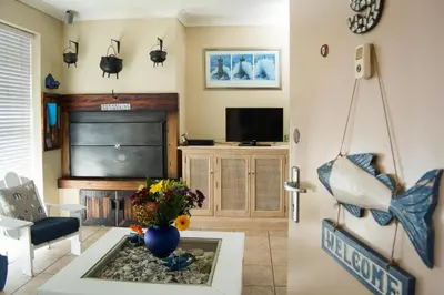 a living room with a fireplace and a tv at 9 Lantra in Strand