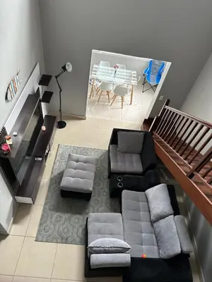 a living room with a couch and a table at YA Eagle Wings Self Catering Shared Single room Lodge B in Cape Town
