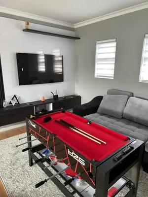 a living room with a pool table in front of a couch at YA Eagle Wings Self Catering Shared Single room Lodge B in Cape Town