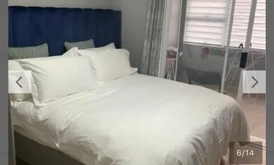 a bed with white sheets and pillows in a bedroom at YA Eagle Wings Self Catering Shared Single Room Lodge A in Cape Town