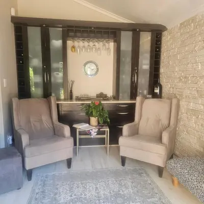 two chairs and a table in a living room at Mimi's in Plattekloof