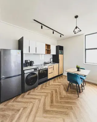 a kitchen with a table and a refrigerator at Peace On Park by Dajosha booking in Cape Town