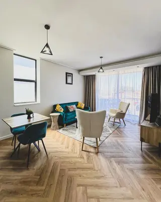 a living room with a couch and a table at Peace On Park by Dajosha booking in Cape Town
