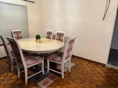 a table and chairs with a plant on top of it at Miches House in Cape Town