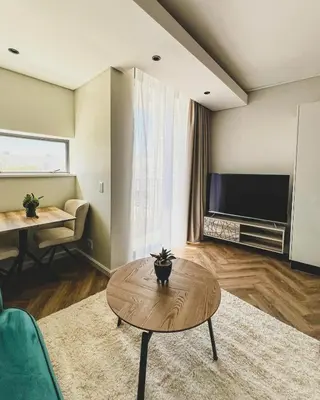 a living room with a coffee table and a tv at Joy On Park by Dajosha Bookings in Cape Town