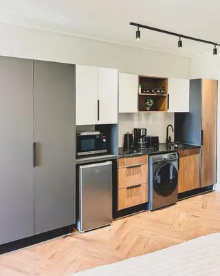 a kitchen with a washer and a dishwasher at Joy On Park by Dajosha Bookings in Cape Town