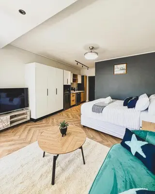 a large bedroom with two beds and a table at Joy On Park by Dajosha Bookings in Cape Town
