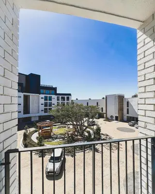 a balcony with a car parked in a courtyard at Joy On Park by Dajosha Bookings in Cape Town