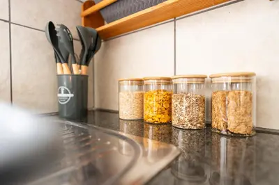 four glass jars filled with food sitting on a counter at Mystical Serenity in Durbanville