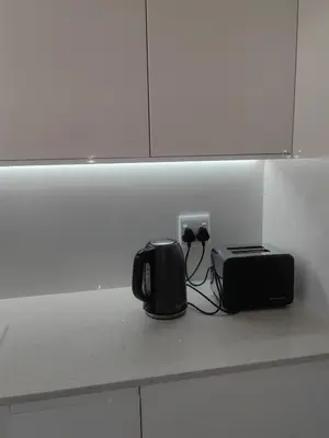 a counter with a toaster and a radio on a wall at Water front apartment-Ocean Palace in Tyger Valley