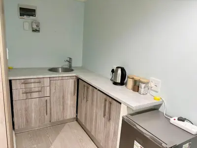 a kitchen with a sink and a counter top at Bachelor Flat A in Goodwood
