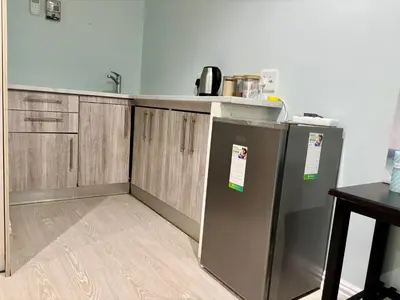 a kitchen with two refrigerators and a counter top at Bachelor Flat A in Goodwood