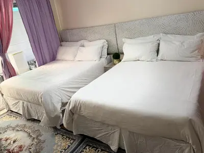 two beds sitting next to each other in a bedroom at Miches House in Cape Town