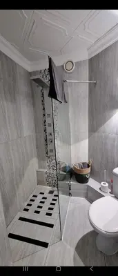 a bathroom with a shower with a toilet and a sink at 210 at Beach in Strand
