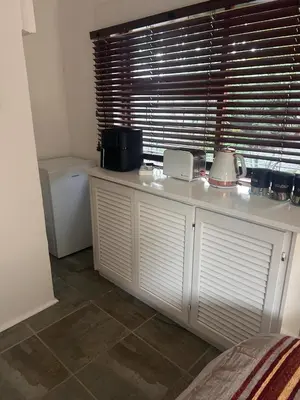 a kitchen with a white counter with a window at Bergstreet in Hermanus