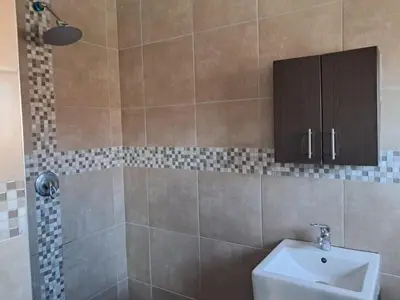 a bathroom with a toilet and a sink and a shower at Spacious Home-Quiet area, Kuils river, Cape Town in Blackheath