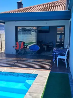 a house with a swimming pool and a patio at Spacious Home-Quiet area, Kuils river, Cape Town in Blackheath