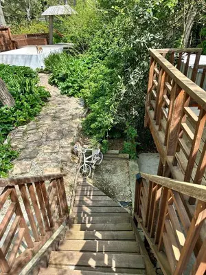 a bike is chained to a wooden bridge at Green Cottage, Elgin Grabouw in Grabouw