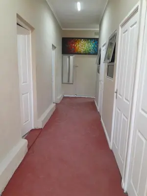a corridor with a red carpet in a hallway at BDC Paarl Accommodation and Guest House in Paarl
