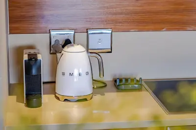 a blender sitting on a counter in a kitchen at Hermanus Marine Square spacious 1 bedroom- central & close to sea in Hermanus