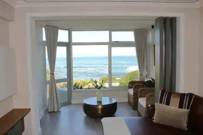 a living room with a view of the ocean at Bayview 107 in Hermanus